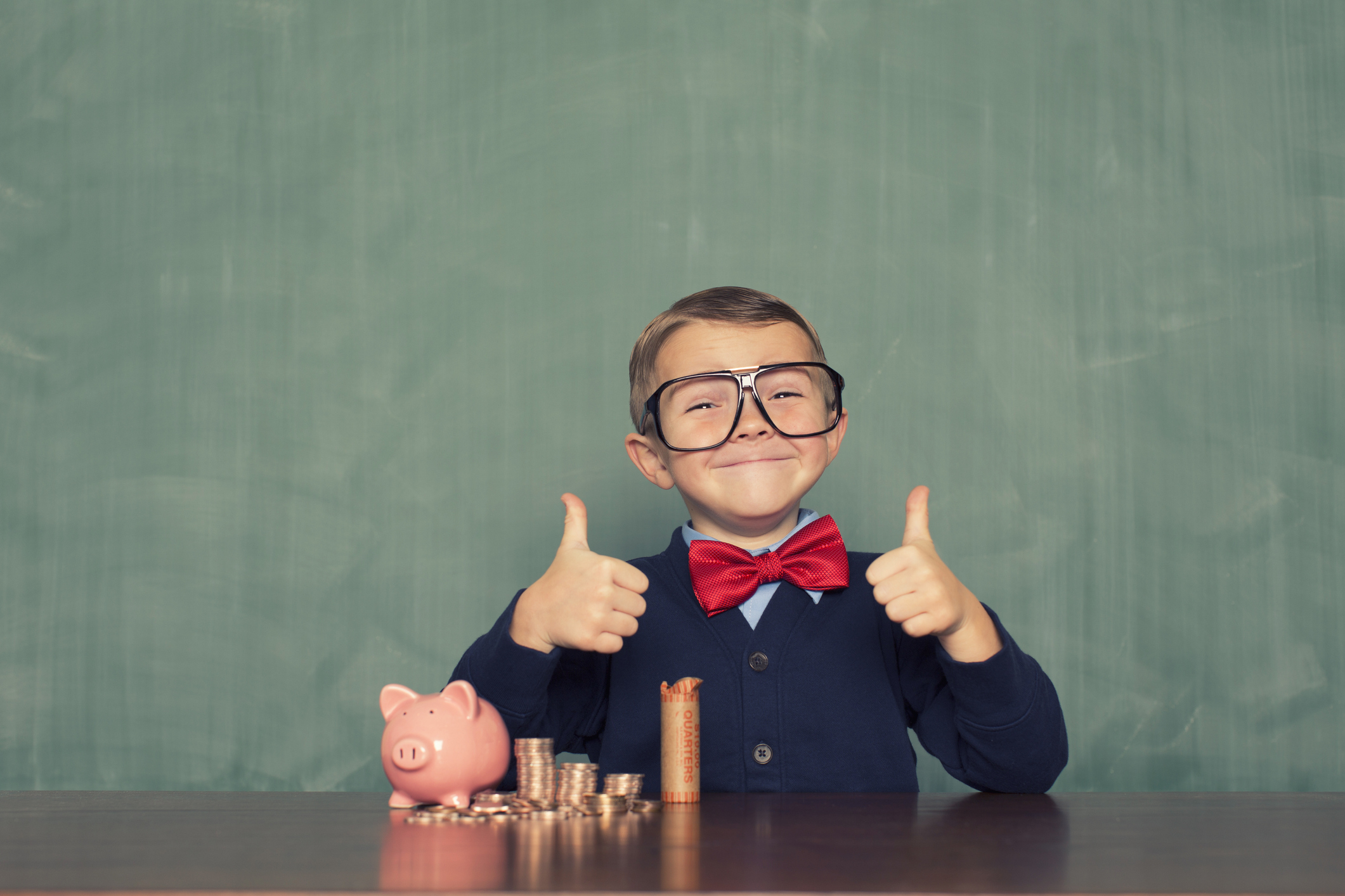 A young boy is excited about saving money for the future